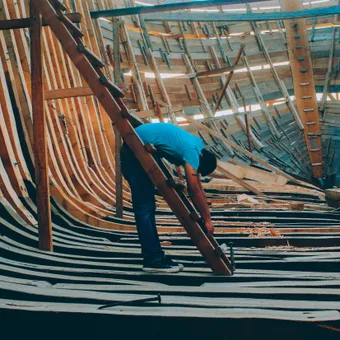 A crew member working on a roof edge during a gutter project